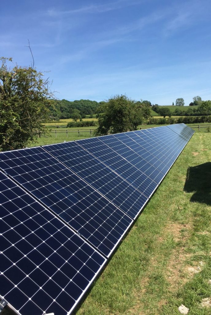 long row of solar panels in a field